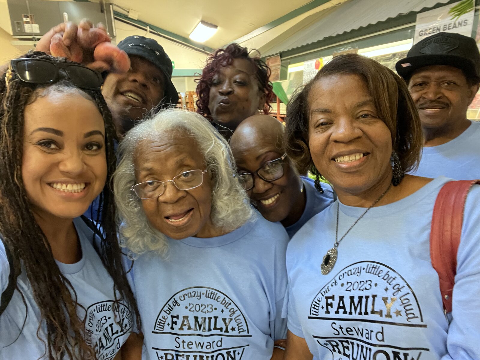 Steward family members in blue reunion t-shirts taking a group selfie at Country Mercantile