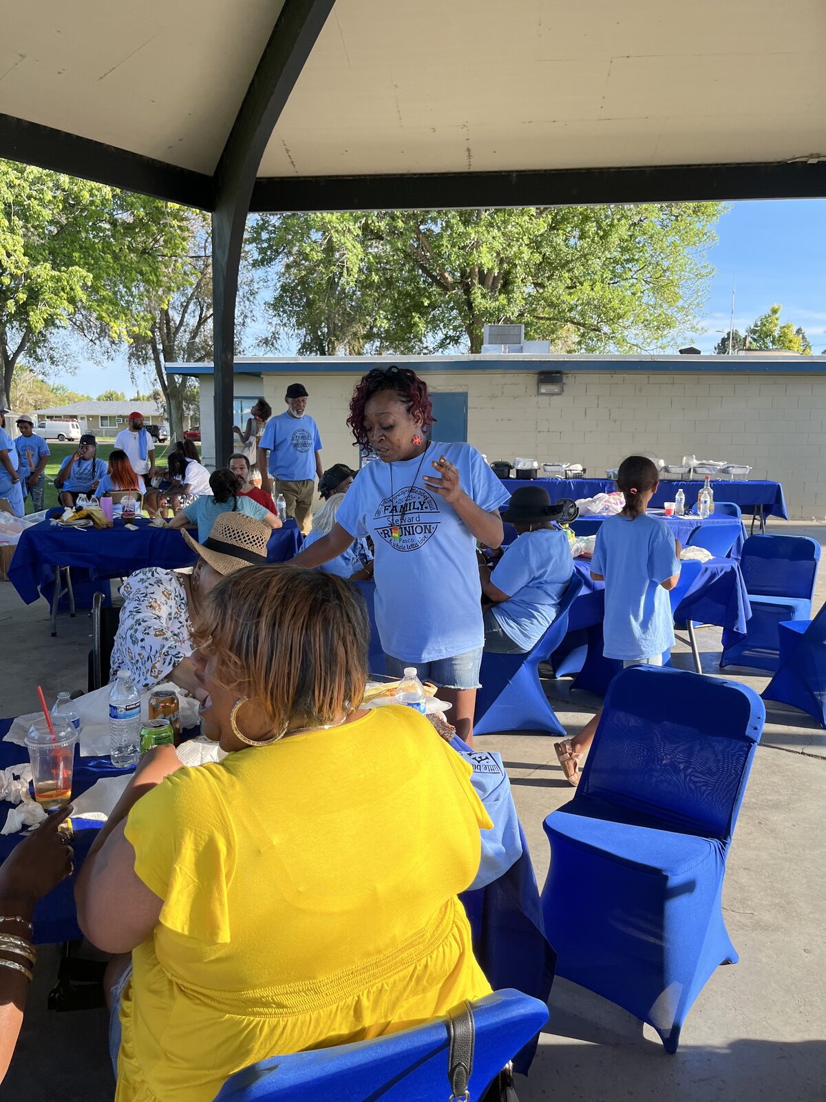 Steward family members at the cookout pavilion in reunion t-shirts